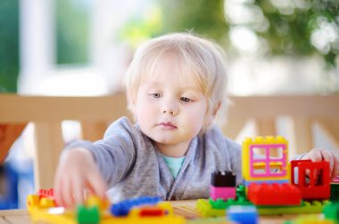 Küçük çocuk anaokulu, renkli plastik bloklarla oynama.