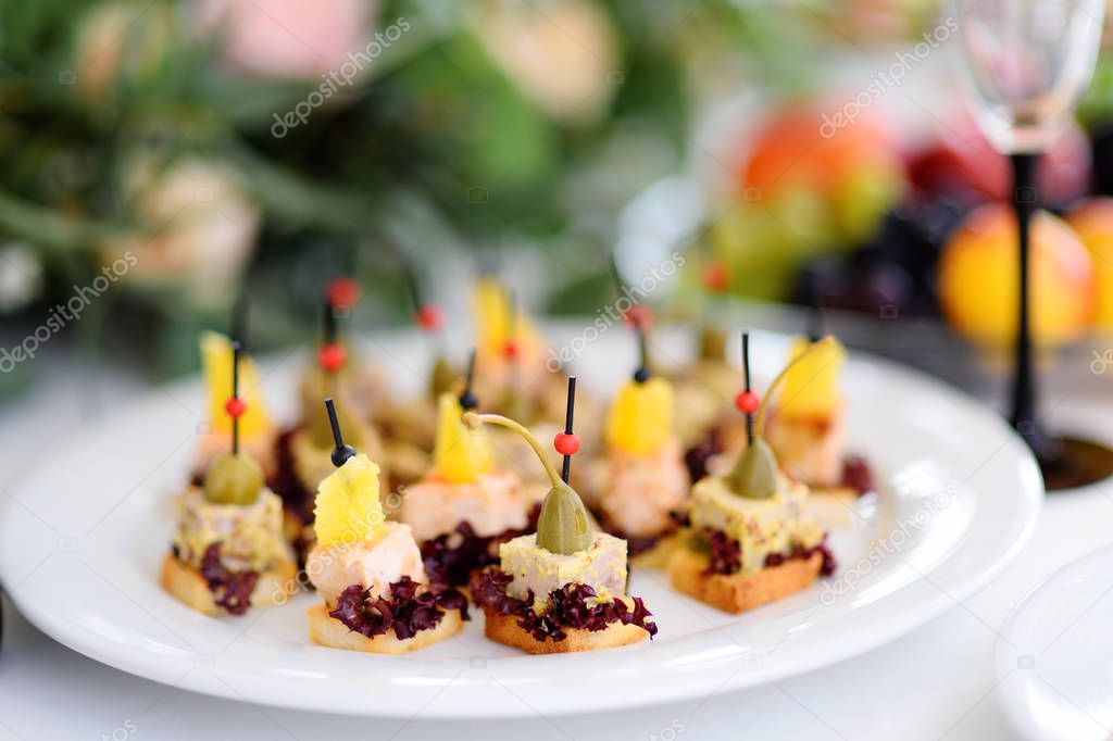 Plates with assorted appetizers on an event party or dinner.