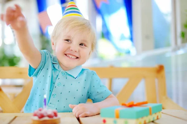 Милый мальчик веселится и праздновать день рождения с красочным украшением и торт — стоковое фото