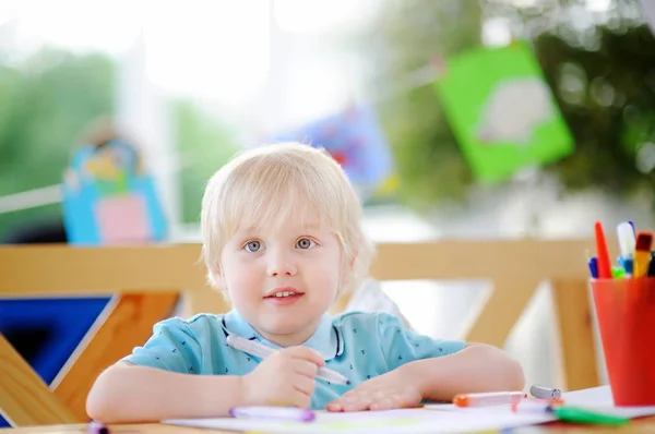 Lindo niño pequeño dibujo y pintura con rotuladores de colores en el jardín de infantes —  Fotos de Stock