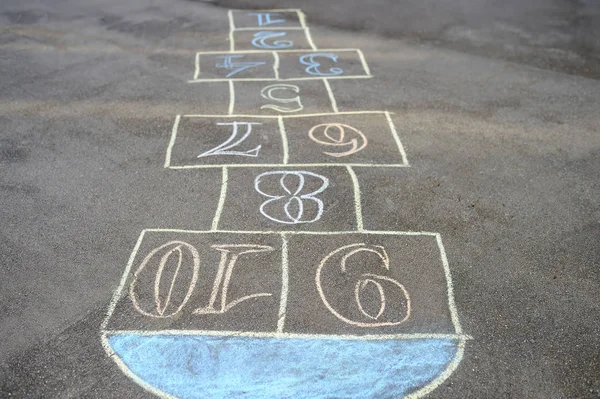 Chalk-painted hopscotch on asphalt — Stock Photo, Image