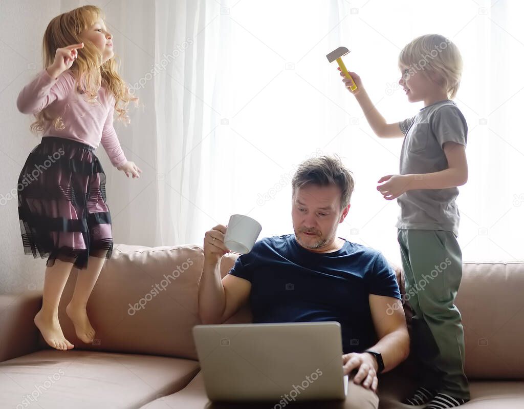 Tired father with his two kids during quarantine. Stay at home concept. Online working and household at the same time while quarantine. Exhausted parents with children.