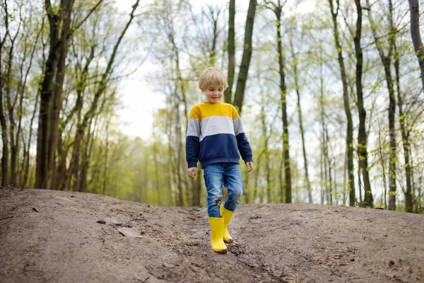 Mischievous Förskolebarn Bär Gula Regnstövlar Promenader Vid Lerig Väg Han — Stockfoto