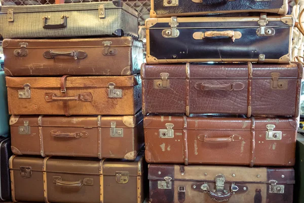 Vintage old battered leather suitcases stacked — Stock Photo, Image