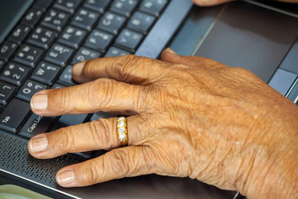 Old person hands typing
