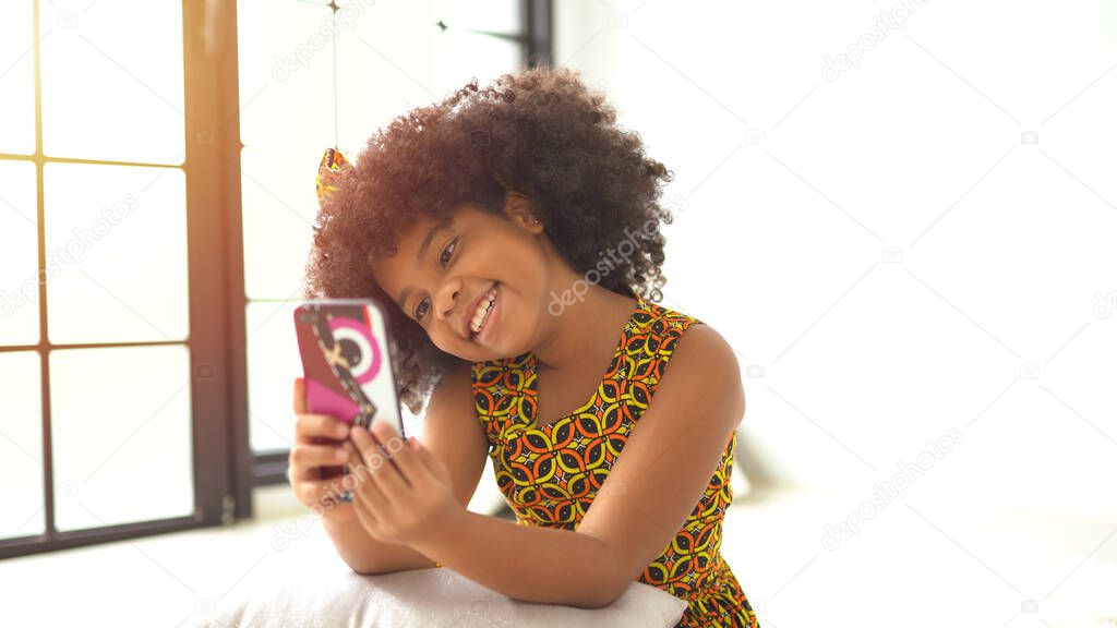 Cute african american girl making a selfie on a mobile phone.