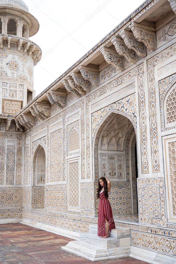 Asian woman in Tomb of Itimad-ud-Daulah in Agra, Uttar Pradesh, India. This Tomb is often regarded as a draft of the Taj Mahal.