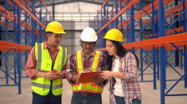 Depo çalışanları çalışırken sevkiyatı kontrol ediyorlar