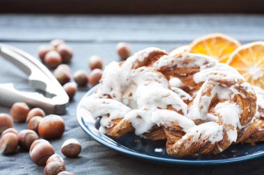 Ezilmiş fındık ve limon fondan mavi tabakta ile Bavyera kremalı pasta. Arka planda bir fincan çay ve kurutulmuş Portakal dilim