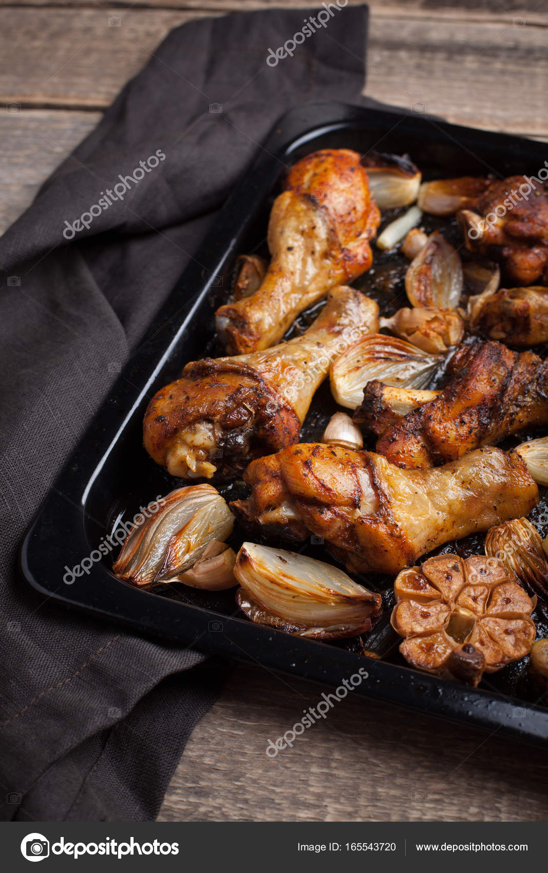 Oven Baked Chicken Leg Quarters With Onion Garlic And Capsicum On A Dark Background Closeup Top View Stock Photo Image By C Vasiliybudarin 165543720