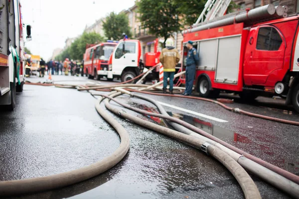 Arka planda yangın kamyon ve iş yerinde itfaiye Yangın hortumlar