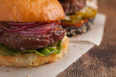 Üç mini dizi closeup ev yapımı Burger mermer sığır eti ve sebze ahşap oyun tahtası