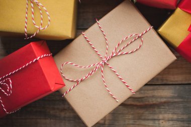 Noel hediye kutuları ahşap arka plan üzerinde arka plan. Üstten Görünüm. Yeni yıl veya kutsal Sevgililer günü için güzel paketlenmiş çok renkli hediyeler