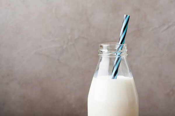 Бутылка с молоком на темном фоне с копировальным пространством
