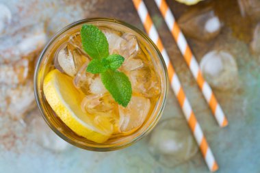 Limon, nane ve uzun boylu gözlük buz ile geleneksel buzlu çay. Yaz içeceği eski paslı arka plan üzerinde serinletici bir bardak. Üstten Görünüm