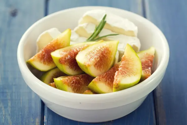 Figs with cheese in white bowl — Stock Photo, Image