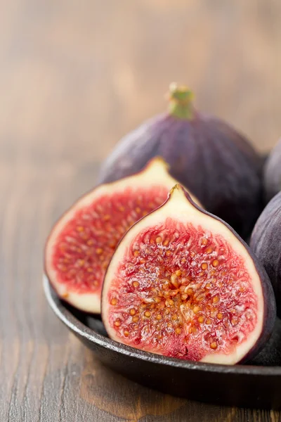 Figs on brown wooden background — Stock Photo, Image