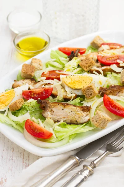 Chicken salad with boiled egg on white dish — Stock Photo, Image