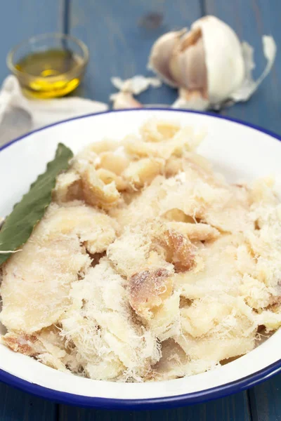 Salted cod fish on white dish — Stock Photo, Image