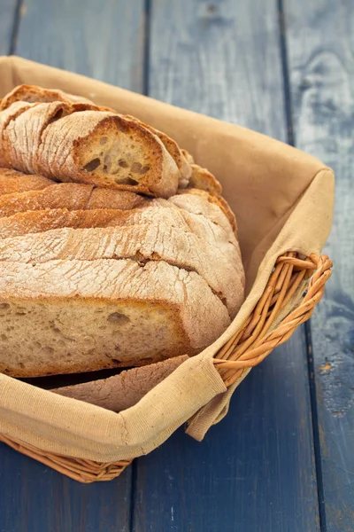 Bread in basket on blue background — Stock Photo, Image