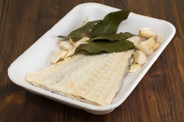 Salted cod fish on white dish — Stock Photo, Image