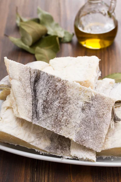 Salted raw dry cod fish on dish — Stock Photo, Image