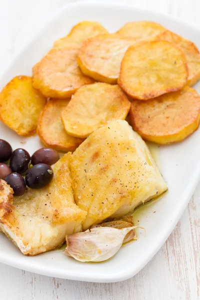 Gebratener Kabeljau mit Kartoffeln auf weißem Teller — Stockfoto