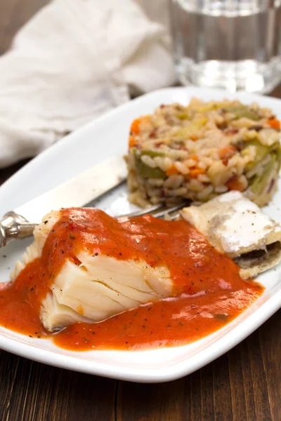 Boiled cod fish with tomato sauce and rice on plate — Stock Photo, Image