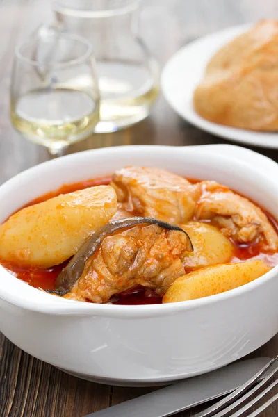 Fish stew on white bowl on wooden background — Stock Photo, Image