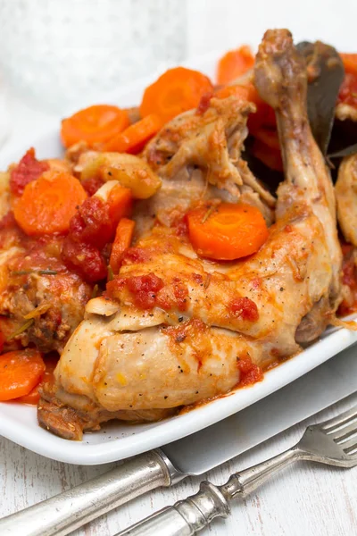 Rabbit stew with carrot and tomato on white dish — Stock Photo, Image