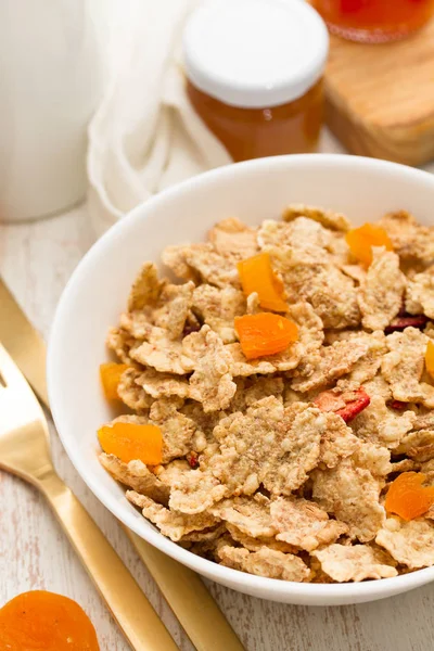 Cereals with dry fruits in bowl and jam — Stock Photo, Image