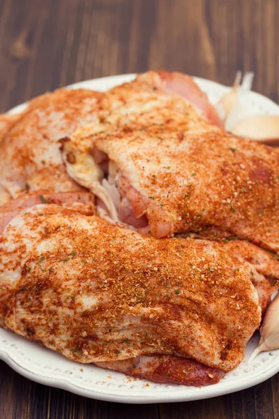 Raw chicken with herbs  on white plate — Stock Photo, Image