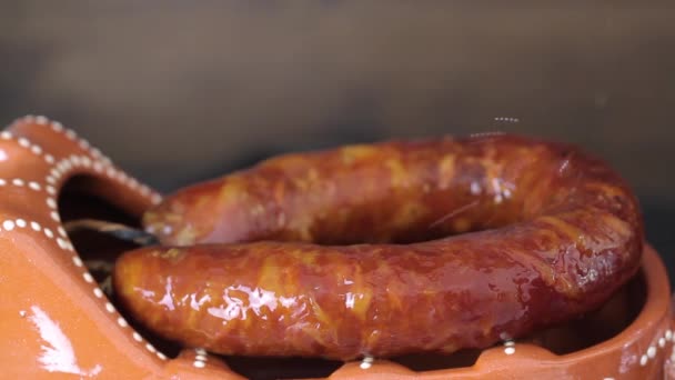 Traditional portuguese smoked sausage in ceramic dish — Stock Video