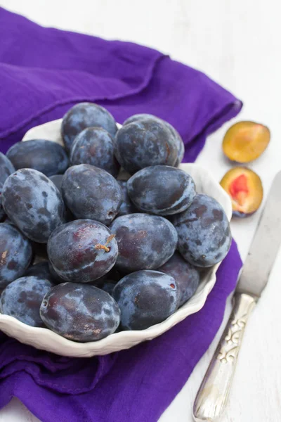 Fresh plums in white bowl — Stock Photo, Image