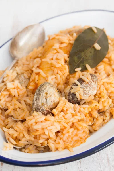 Rice with seafood and fish on dish on wooden background — Stock Photo, Image