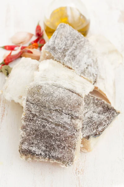 Salted dry codfish on white wooden background — Stock Photo, Image