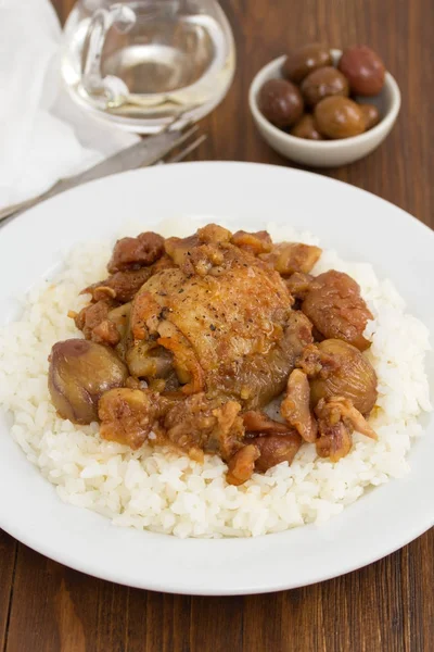 Chicken with chestnuts and boiled rice on dish — Stock Photo, Image