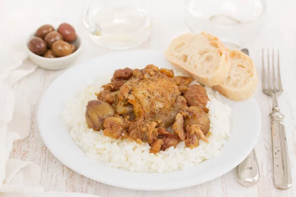 Chicken with chestnuts and boiled rice on dish — Stock Photo, Image