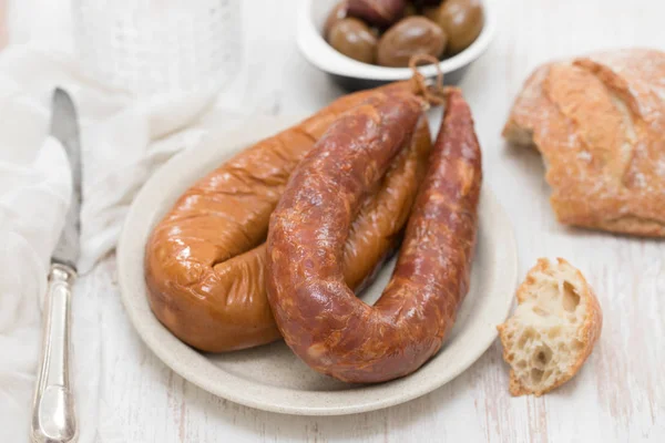 Smoked portuguese sausages on white plate — Stock Photo, Image