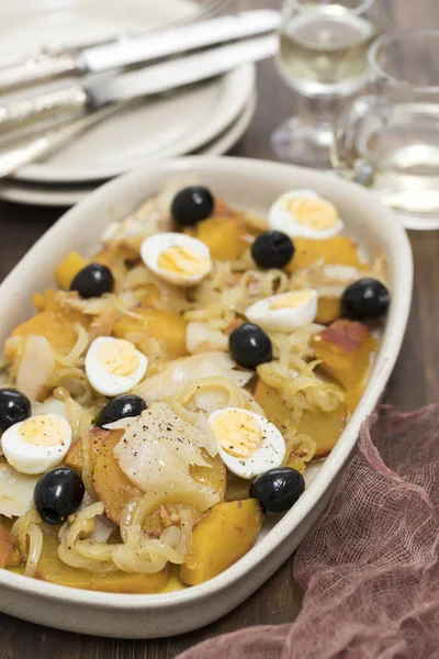 Сладкий картофель с треской, луком и яйцами на блюде — стоковое фото