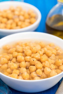 ahşap arka plan üzerinde beyaz kase haşlanmış nohut