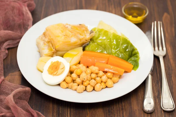 Boiled cod fish with potato, carrot, cabbage , chick-pea and egg — Stock Photo, Image