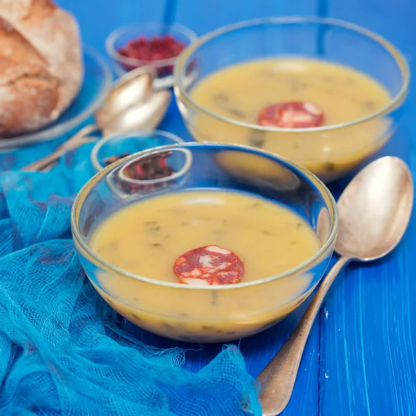 Soup with spinach and smoked sausage in small bowls — Stock Photo, Image