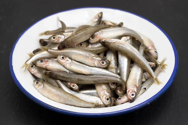 Small fish in white plate — Stock Photo, Image