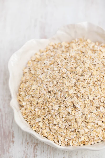 Oat meal in white bowl — Stock Photo, Image