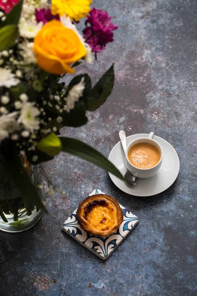 beautiful flowers and coffee with pastel de nata