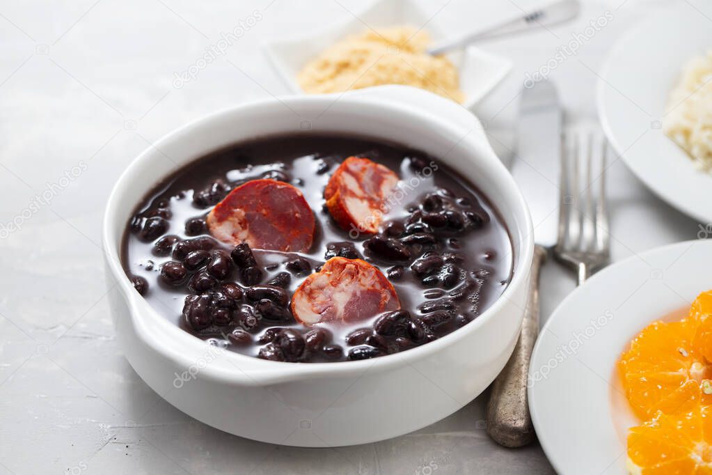 typical brazilian food black beans with smoked sausages in white
