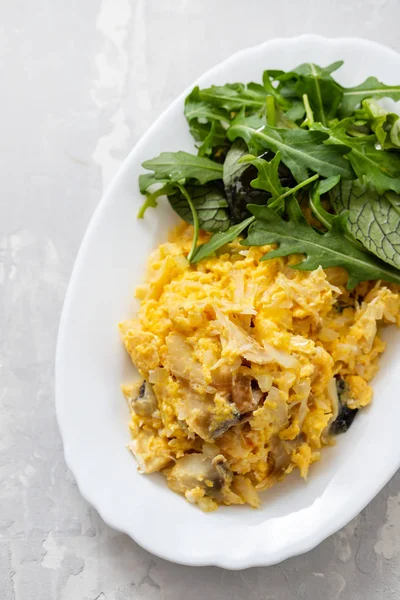 Cod fish with mashed eggs on the dish on ceramic background — Stock Photo, Image