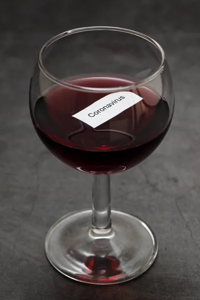 glass of red wine on dark background