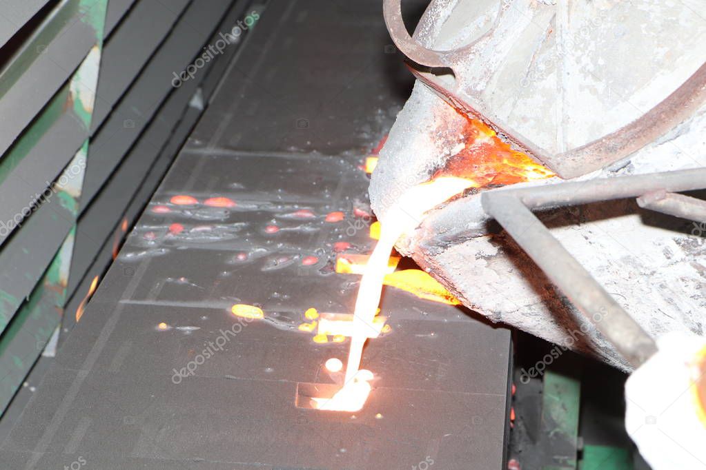 Iron molten metal pouring in sand mold 